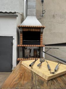 a wooden cutting board with knives on top of a stove at Casa Herrero Valderrobres in Valderrobres +36 photos