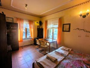 a bedroom with a bed and a desk and windows at Nature Home Maitreya in Lorca
