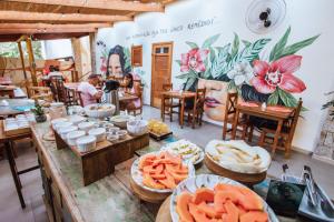 a room with a table filled with plates of food at Smart Hotel Reserva Ilhabela in Ilhabela +108 photos