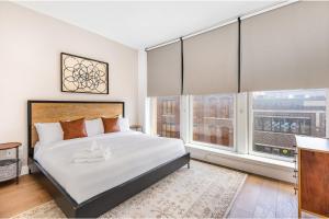 um quarto com uma cama grande e duas janelas em The Saddlery - Showroom - Walk to Broadway em Nashville