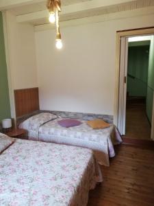 Posteľ alebo postele v izbe v ubytovaní La Casetta Della Mamy