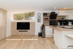 a living room with a television on a brick fireplace at Apartment Puntamica in Zadar