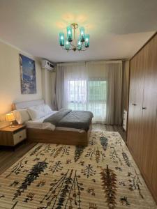 a bedroom with a bed and a chandelier at Down Town New ELalamein خلف الابراج وبجوار فندق ريكسوس العلمين in El Alamein