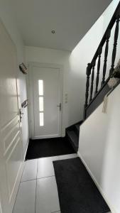 a white hallway with a staircase and a door at Maison du Mont César in Montchaton +33 photos