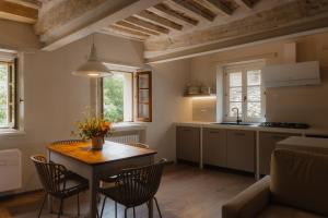 a kitchen and dining room with a table and chairs at Il Pozzo RestArt in San Casciano dei Bagni