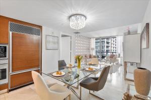 a dining room with a glass table and chairs at MVR - Ocean & River Views Boutique Apt SPA Pool in Miami