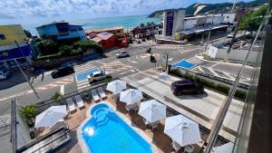 a view of a city with a pool and umbrellas at Las Brisas Beach Hotel in Natal