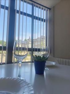 two wine glasses sitting on a table in front of a window at Remanso de paz in Mondariz-Balneario