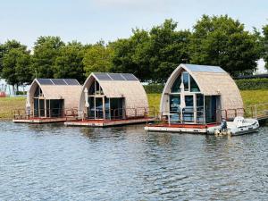 three domes with solar panels on the water at deBieslodge in Drimmelen