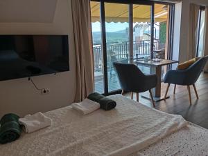 a bedroom with a bed with a view of a balcony at Apartments Provence in Sozopol