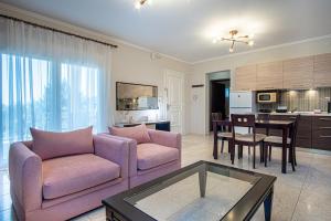 a living room with a couch and a dining room at Casa Freya in Alexandroupoli