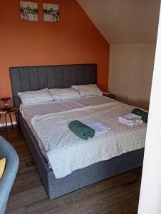 a bedroom with a large bed with two towels on it at Apartments Provence in Sozopol