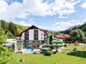 a large building with a water park with a slide at Familienhotel Trebesingerhof in Trebesing
