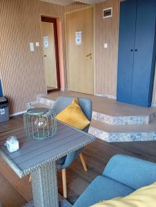 a living room with a table and a couch at Apartments Provence in Sozopol +44 photos