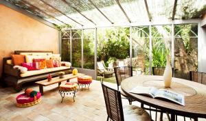a screened in patio with a table and chairs at Maison Jolie in Saint-Tropez