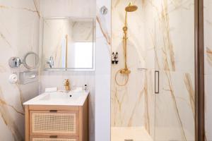a bathroom with a sink and a shower at Grand Hotel Des Lecques; BW Signature Collection in Saint-Cyr-sur-Mer