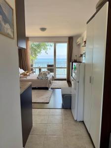 a room with a kitchen and a bedroom with a balcony at Apartment Porto Chernomoretz in Chernomorets