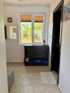 a living room with a dresser and a window at Apartment Porto Chernomoretz in Chernomorets