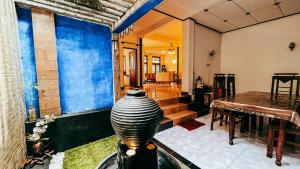 a living room with a vase in the middle of a room at Dadas Villa in Kandy