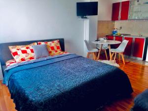 a bedroom with a bed and a table with chairs at apartman berane in Berane +1 photo