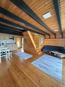 a large living room with a table and a couch at Azhara Bungalow in Soğuksu