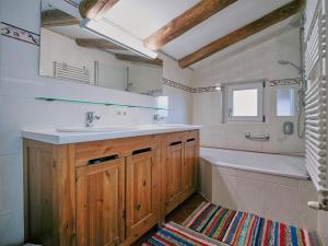 a bathroom with a sink and a bath tub at Haus ANTONIUS - AlpenLuxus Collection in Reith im Alpbachtal +24 photos