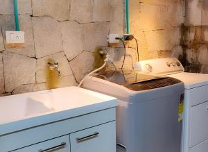 a bathroom with a sink and a washing machine at Casa central el mejor distrito in Bogotá +25 photos