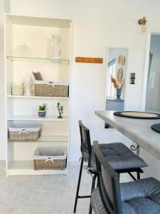 a dining room with a table and chairs and shelves at Giorgos concept suites AGAPI in Edipsos +21 photos