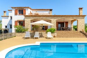 a villa with a swimming pool and a house at Ca la Goyi in Caldes de Malavella