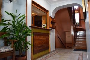 a hallway with a wooden door and a plant at Pensión Montarto in Arties