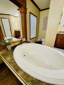 a large white bath tub in a bathroom at Mark House in Hammond +114 photos