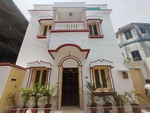 a white building with a door in front of it at ROAMERS INN Backpackers Hostel in Kolkata