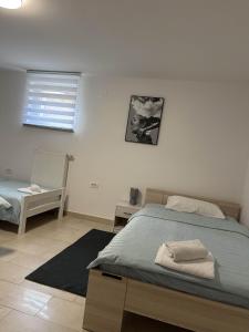 a bedroom with a bed and a table and a window at Apartments Dani in Postojna