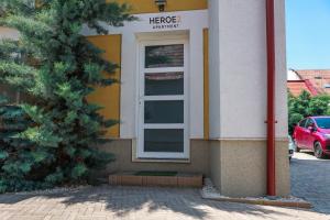 a building with a window with a sign on it at Heroes Apartment Esztergom in Esztergom