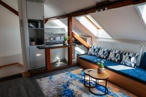 a living room with a blue couch and a table at Heroes Apartment Esztergom in Esztergom