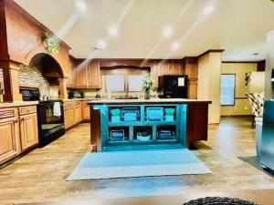a large kitchen with wooden cabinets and a blue island at Mark House in Hammond