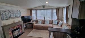 a living room with a couch and a fireplace at Island Escape Sandown in Sandown