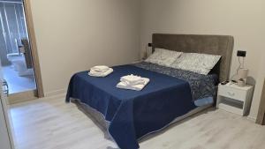 a bedroom with a bed with two towels on it at Casa Vacanze Mannara in Scilla