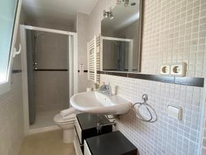 a bathroom with a sink and a toilet and a mirror at Reconnectar Blanes Montserrat in Blanes +9 photos