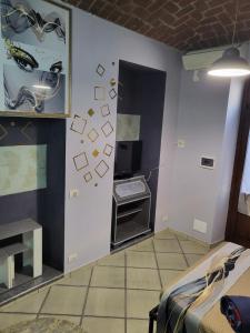 a room with a bed and a computer on a wall at A casa di ninni ''Ormea room'' in Turin