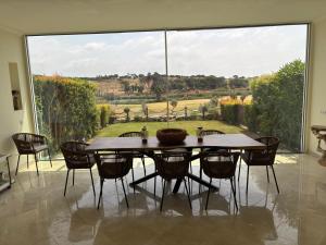 a dining room with a table and a large window at Formosa Villas in Quinta do Lago +13 photos