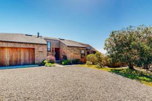 a brick house with a garage and a driveway at Cadwalader House in Sea Ranch