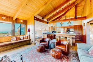 a living room with a couch and chairs and a kitchen at Cadwalader House in Sea Ranch