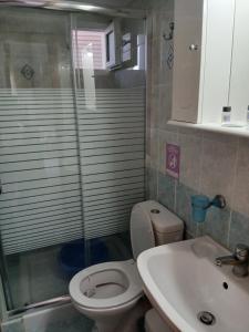 a bathroom with a shower and a toilet and a sink at ELENA SEAVIEW house in Argostoli +77 photos