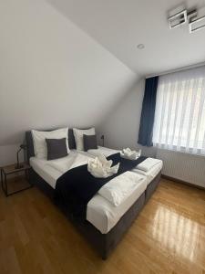 a bedroom with a large bed with two dishes on it at Odea Ferienhaus in Soltau +16 photos