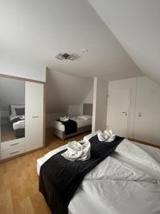 a bedroom with a bed with two towels on it at Odea Ferienhaus in Soltau