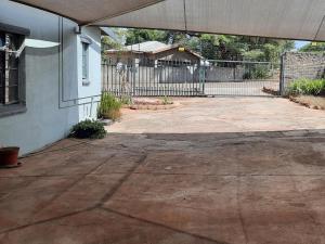 an empty driveway in front of a house at Kalahari Kaja in Kuruman +3 photos