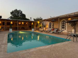 a swimming pool in front of a building at Riad Eucalyptus, hôtel de charme Essaouira in Essaouira