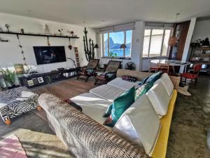 a living room with two couches and a tv at Lux 12 - Cobertura Romantica com piscina aquecida e vista mar in Rio de Janeiro