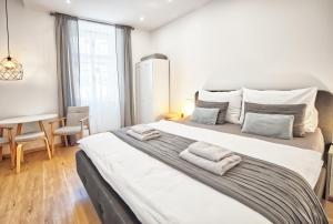 Posteľ alebo postele v izbe v ubytovaní Apartmány VIENNA